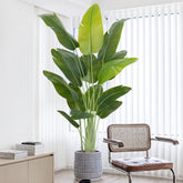 Tall artificial bird of paradise banana tree with lush green leaves in textured gray pot perfect for indoor use