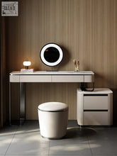 Modern white kelvin dressing table with sleek metallic legs and circular led mirror mounted above for stylish use