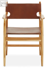 Kendari antique brown leather chair with minimalist wooden frame and circular cutouts on arms brown leather chair