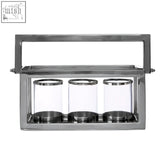 A kensington townhouse stainless steel candle holder with polished chrome finish and four clear glass holders in a row