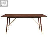 A sleek kenso walnut wood dining table with a dark wood top and brass finish base perfect for stylish dining rooms