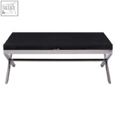 Kerala black coffee table with sleek chrome x-shaped legs and a black glass top for modern living spaces