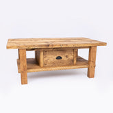 Keswick coffee table made of reclaimed wood with a drawer and lower shelf in natural light brown tones. free furniture care