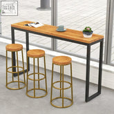 Industrial-style bar table with rustic wooden top and black metal frame paired with three gold koki bar stools
