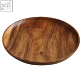 Smooth oval-shaped acacia large round plate with warm brown finish and natural wood grain patterns by kora acacia large round