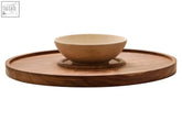 A warm acacia wood chip and dip platter with a cream marble chip bowl on a rotating serving tray
