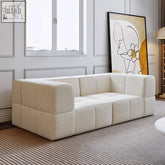 Cream-colored koto sofa with plush deep cushions and a tufted blocky modular design for cozy seating