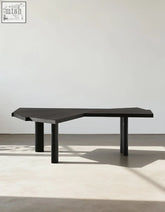 Black matte wooden Kwan corner office desk with geometric top and cylindrical legs perfect for a corner office setup
