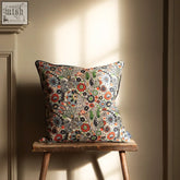 A kyoto woodblock square cushion with vibrant orange red green floral pattern on off white made from ethically sourced materials