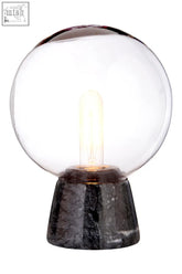 Lamonte globe lamp with black marble base featuring a clear glass globe and exposed filament bulb on black marble