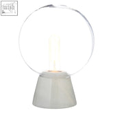 Lamonte globe lamp featuring a clear glass globe with an exposed filament bulb on a white marble base