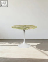 Langenfeld round dining table with a sleek green marble top and minimalist white pedestal base perfect for round dining