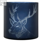 Large blue stag candle holder made of deep blue glass with an intricately etched white stag head design