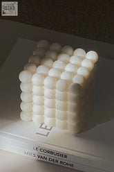 Large bubble candle is a white cube candle made of spherical wax bubbles arranged in a grid pattern