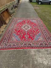 A vibrant large red oriental bibikabad rug with wool pile and intricate floral patterns from hamadan region