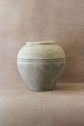 Large white rustic indonesian pot no 26 made of light gray matte ceramic with rounded body and subtle horizontal banding