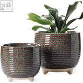Dark ceramic plant pots with horizontal ridges and speckled glaze on light feet perfect for indoor plants