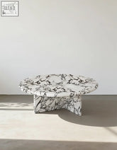 Leanna coffee table featuring a sleek round coffee table design with a white and black marble top and base
