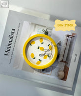 Yellow ceramic lemon trinket dish with glossy finish and white interior perfect for holding small jewelry or keys