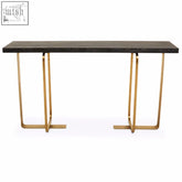 Modern lena console table with dark matte wood top and slender gold metal legs in geometric design