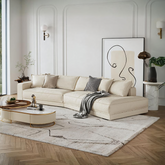 Cream-colored lester four seater curved sofa with plush cushions and a sleek modern design for comfortable seating