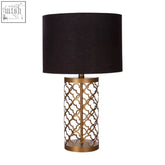 Lexis table lamp with gold table featuring an ornate lattice base and black textured drum shade