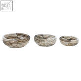 Set of three natural straw woven seagrass baskets from lidi set with black and white detail in natural tones