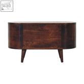 Dark brown oval wooden sideboard with single drawer and tapered legs next to light walnut rounded lid-up blanket box storage bench