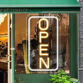 A lightingwill led neon open sign with a warm yellow glow in a rectangular frame perfect for business windows
