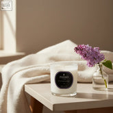 A white parks london lilac candle 220g in clear glass jar with black label offering fresh lilac scent and therapeutic benefits