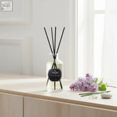 Clear glass lilac diffuser 220ml with black reeds and parks aromatherapy label featuring premium fragrance oils and fresh lilac petals