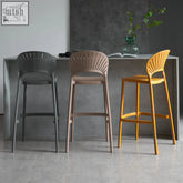 Three lilith bar stools with sleek fan-shaped backrests in gray beige and mustard yellow for modern seating