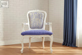 A white ornate lilly salon chair with purple and blue patterned upholstered seat and backrest