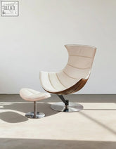 Cream-colored leather lobster lounge chair with wooden base and chrome swivel perfect as a stylish lounge chair