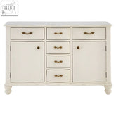 Cream-colored loire white sideboard with distressed finish, six drawers, two cupboards, and brass handles