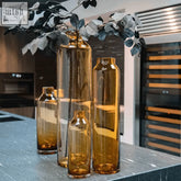 Set of four mouth blown amber glass vases with sleek modern designs from the dutz collection by dutz glass