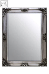 Silver ornate wall mirror with intricate baroque-style detailing in a wooden frame perfect for elegant decor