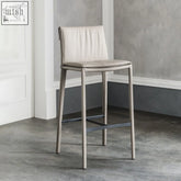 Lorelei bar stool with a sleek light gray leather seat and slender metallic legs for modern seating