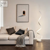 A sleek white led floor lamp with a modern spiral strip design perfect for minimalist lighting setups