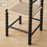Black spindle-legged mae gourd dining chair with woven natural rattan seat perfect for dining rooms