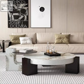 Modern oval makoto coffee table with white marble surface and black geometric legs for stylish living spaces
