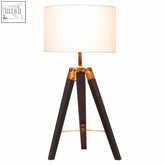 Malvern tripod table lamp with black base featuring dark wood legs gold metal accents and off-white cylindrical shade