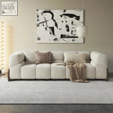 Beige mana sofa with plush cotton fabric and sturdy wooden frame featuring dark wood legs and a modular design
