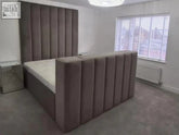 A plush taupe upholstered manchester tv bed with tall tufted headboard and footboard fits tvs and remote control