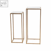 Two mandoli nest side tables with white marble tops and gold iron frames perfect for minimalist spaces
