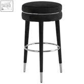 Black velvet bar stool with chrome accents and tapered rubber wood legs for stylish grey velvet bar seating