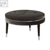 Manhattan grey velvet footstool with dark grey velvet tufted round design and slender black legs with silver caps