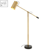 Mano gold floor lamp with gold finish, adjustable height, black circular base, and sleek cylindrical shade