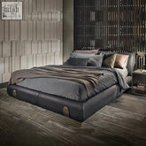 Modern dark gray leather mao bed with plush headboard and subtle metallic accents for contemporary design