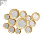 Cluster of marcia hammered gold wall mirrors with gold-toned hammered finish in circular shapes